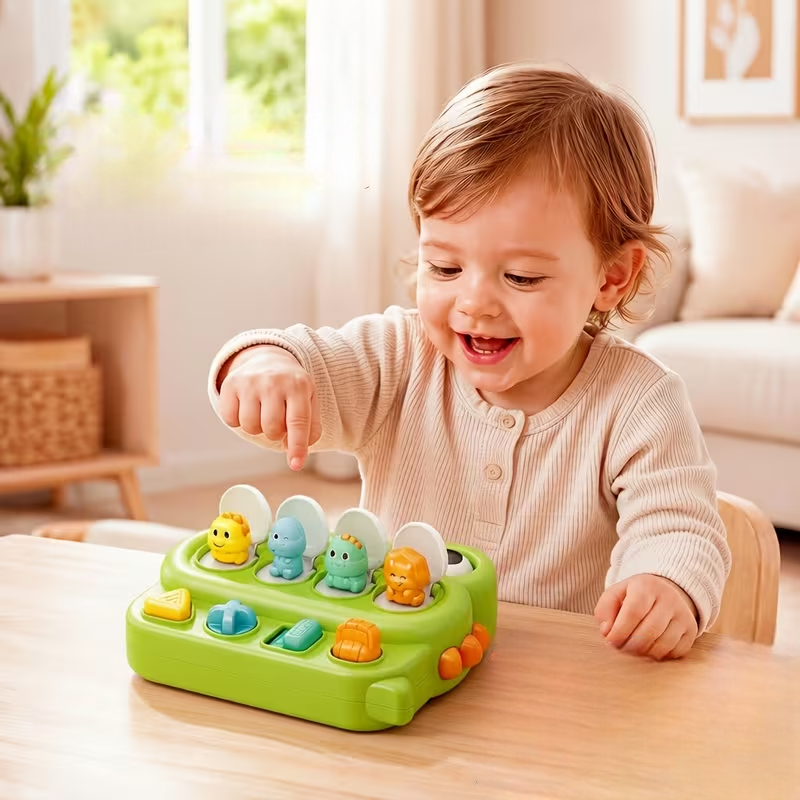 Toddler Pointing at the Dinosaurs Pop-Up Toys